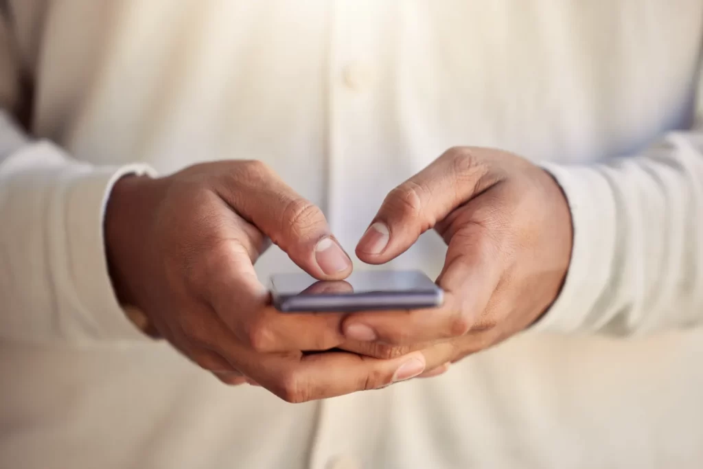 close up of hands using mobile phone utc