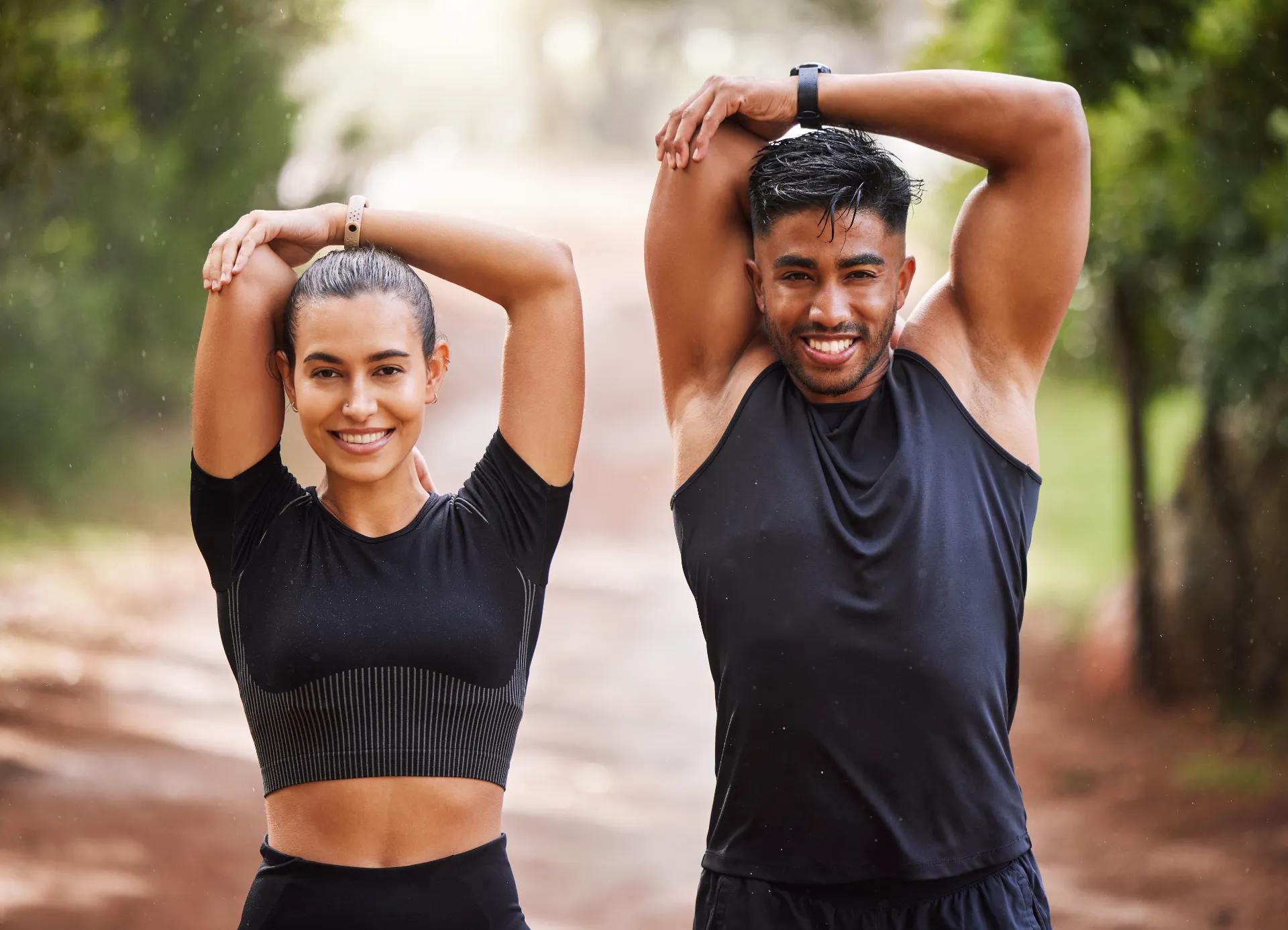 fit couple or active athlete friends stretching a utc
